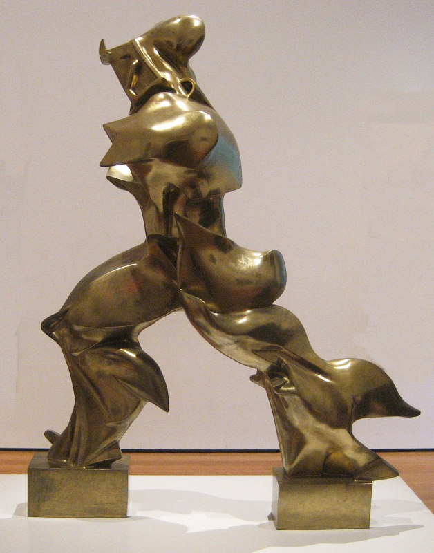 estátua moderna em bronze dourado de um homem que sugere que está caminhando rapidamente